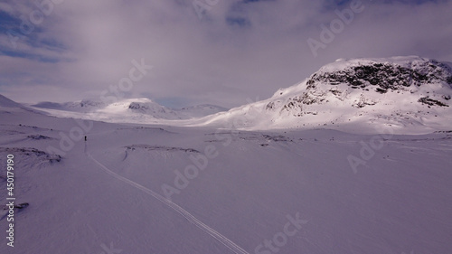 A tiny lonely skier in Lapland near Alesjaure, Sweden, early April