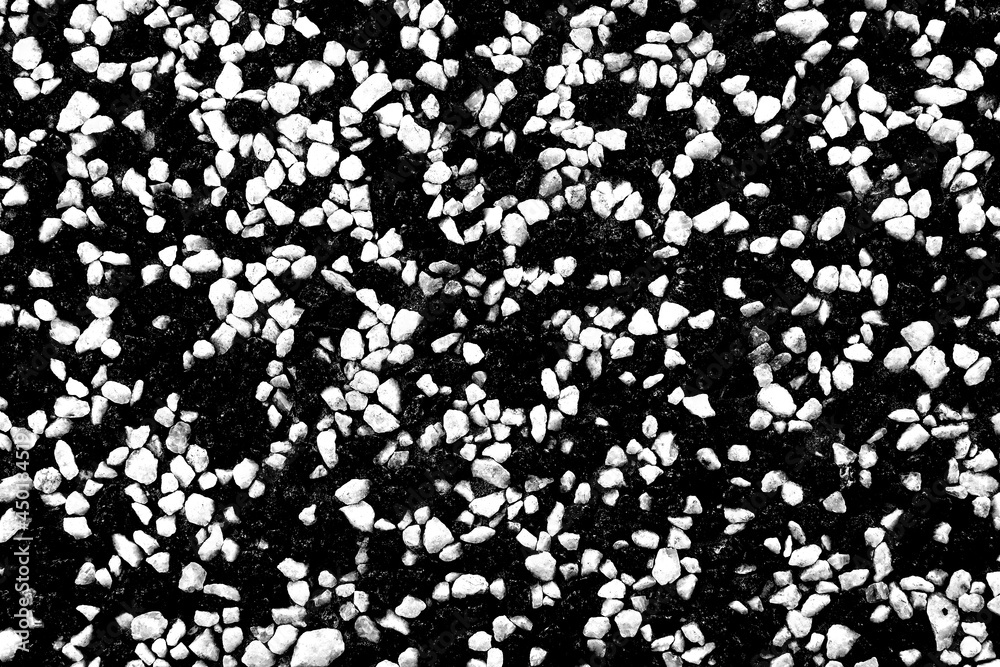 A wall, a floor consisting of many small stones of black and white colors. A wall with cracks A wall, a floor consisting of many small stones of black and white colors. A wall with cracks