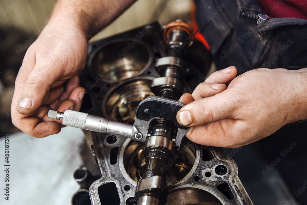 measuring instrument in hands against the background of the engine at a shallow depth of field measuring instrument in hands against the background of the engine at a shallow depth of field