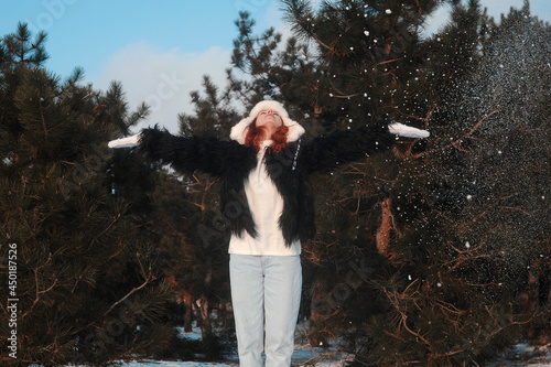 Woman in the snow in forest. Winter holidays.