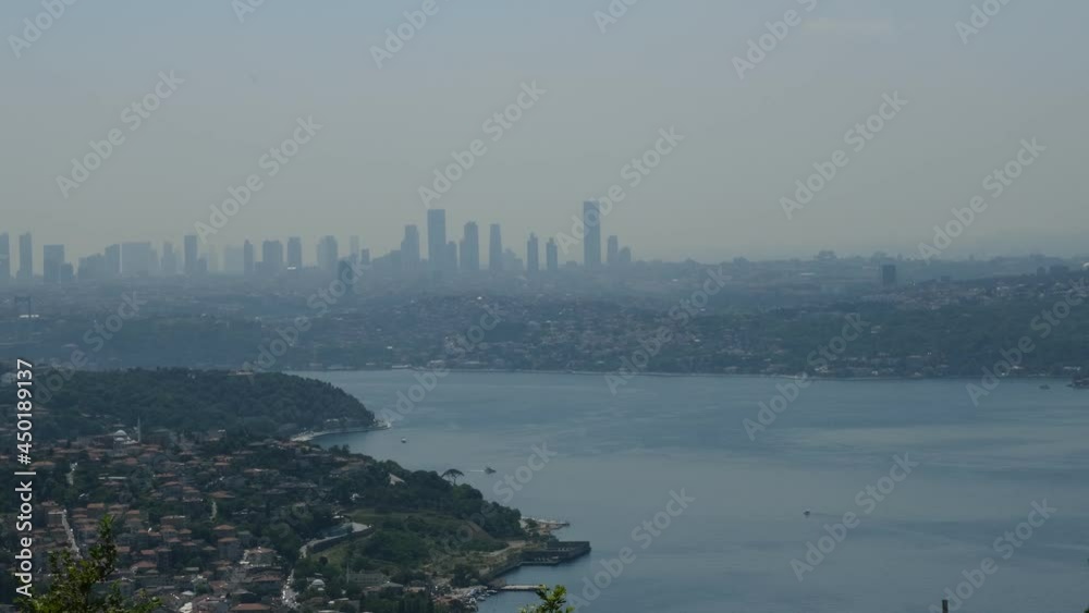 Seascape, Bosphorus is seen between skycrapers and green hills in silhoulette Seascape, Bosphorus is seen between skycrapers and green hills in silhoulette