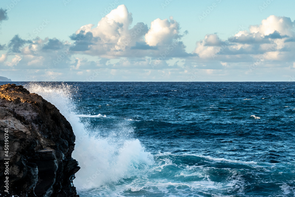 Waves Crashing against rocks in Hawaii.