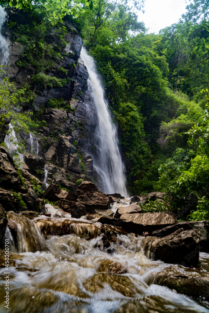 Fototapeta premium Beautiful vertical side shot of the second Tepalo Waterfall in Ajijic Mexico. 