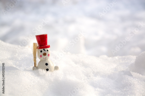  Vintage wooden Snowman in snow. Close up view of snowman in winter snow background.