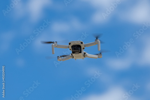 Drone flying in fromt of a blue sky © PRASERT