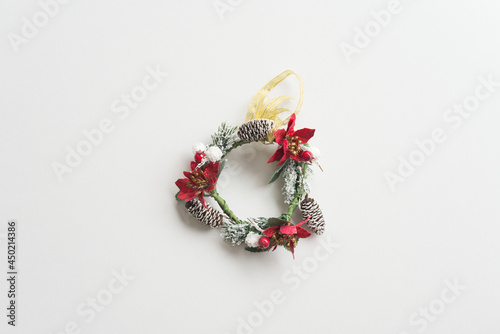Flat lay of Christmas wreath on white background copy space minimal style. Christmas ornament for decoration in Christmas Eve, xmas new year festival.
