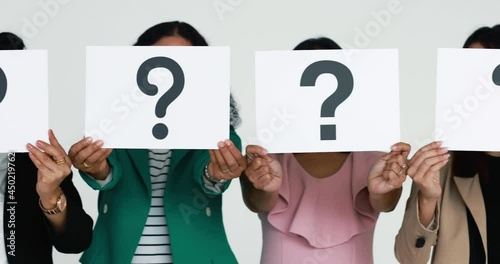 Group in row of businesspeople in business clothes hold paper with question mark signs in symbol of asking and need for answers. Concept of losing patience and show problems in working or job.