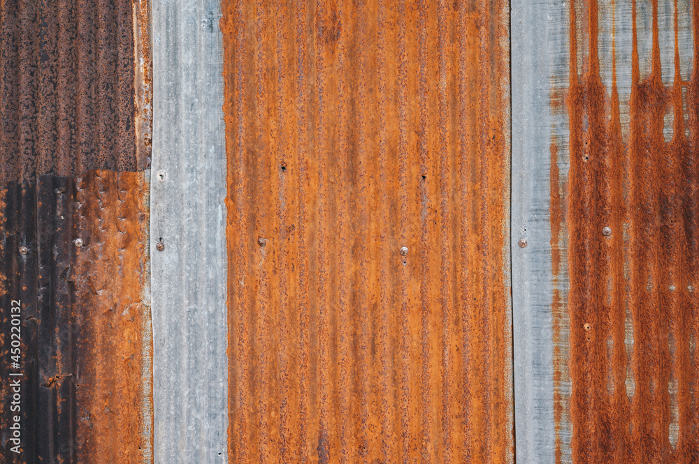 An old rusty metal sheet roof textured. Rust is an iron oxide formed by the reaction of iron and oxygen in the catalytic presence of water or air moisture. An old rusty metal sheet roof textured. Rust is an iron oxide formed by the reaction of iron and oxygen in the catalytic presence of water or air moisture.