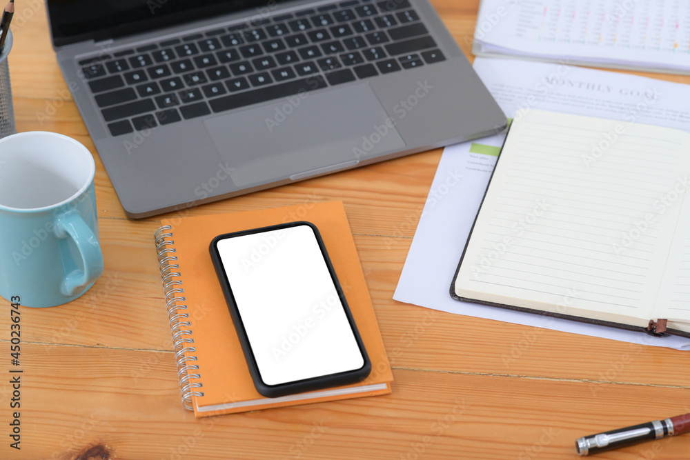 Mock up mobile phone, notebook, laptop and coffee cup on wooden desk. Mock up mobile phone, notebook, laptop and coffee cup on wooden desk.