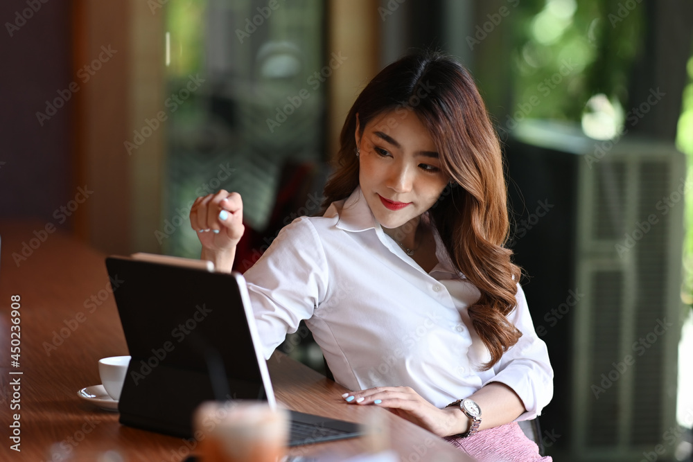 Attractive businesswoman working with computer tablet at modern workplace. Attractive businesswoman working with computer tablet at modern workplace.