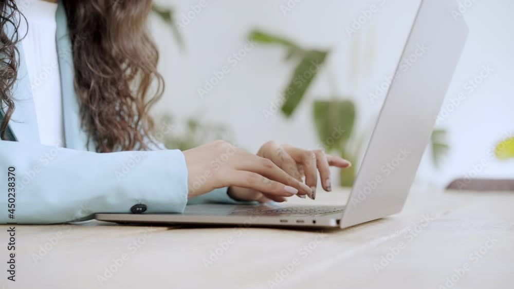 Close up of business woman hands typing on laptop keyboard. Female office worker in formal suit works in modern office in slow motion. Close up of business woman hands typing on laptop keyboard. Female office worker in formal suit works in modern office in slow motion.