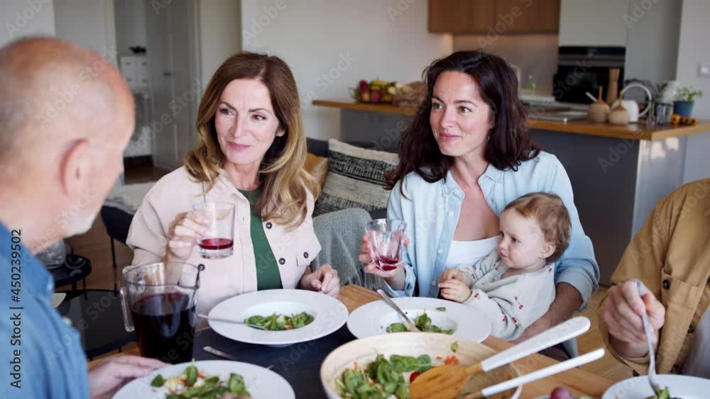 Happy multigeneration family indoors at home eating healthy lunch. Happy multigeneration family indoors at home eating healthy lunch.