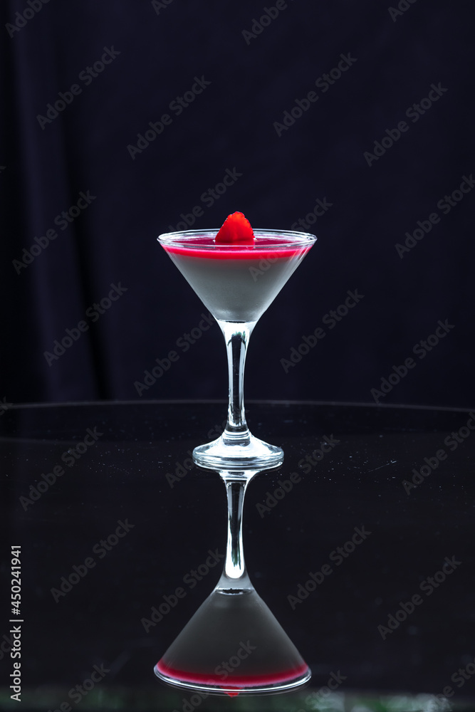 Panna Cotta with strawberry cream isolated on a dark black background