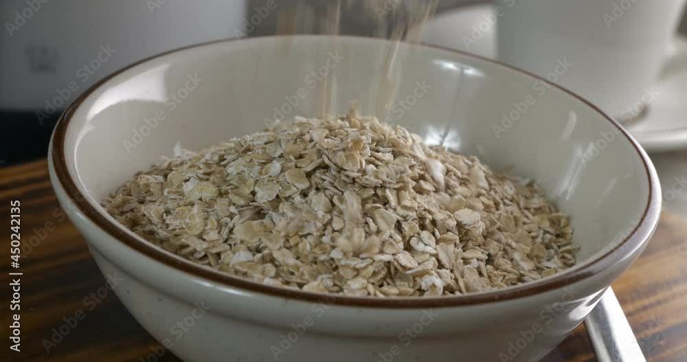 Pouring instant oatmeal into a bowl, slow motion
Pouring instant oatmeal into a bowl, slow motion