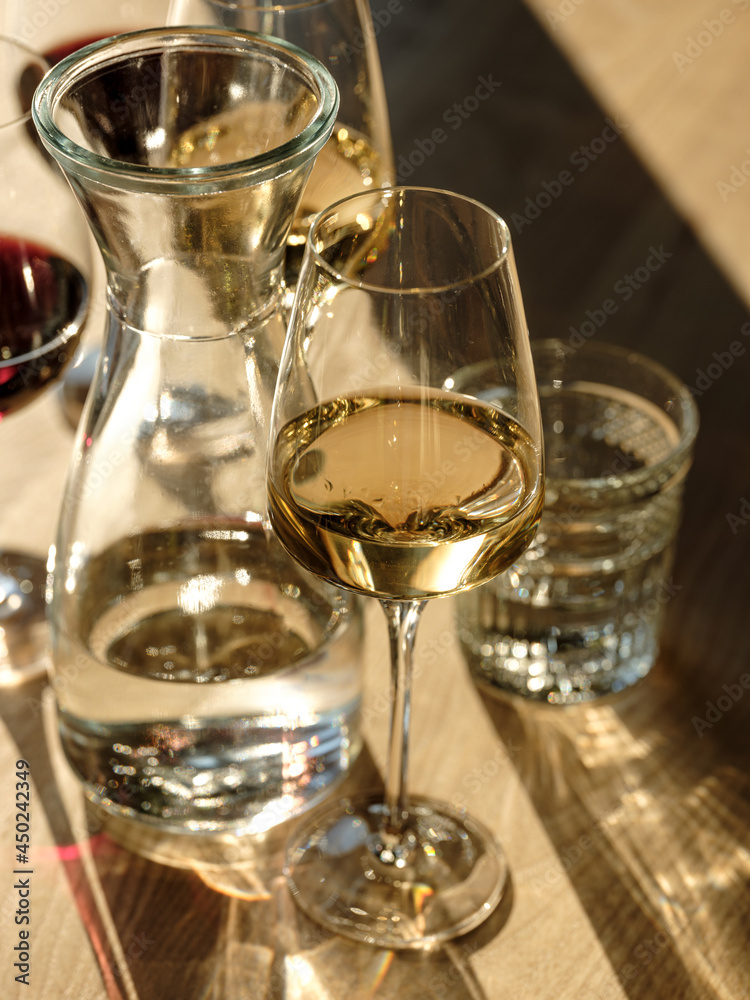 Pizza and drinks - wine and cocktail in natural sunlight on wooden table in restaurant interior background for friends holiday party time. Traditional Italian bread and cuisine recipe