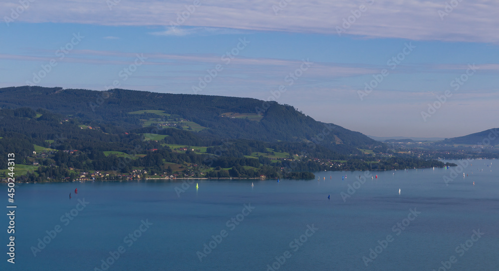 Lake attersee at morning cloudy sky with small sailboat ship from hill schoberstein. Austria, Salzburg