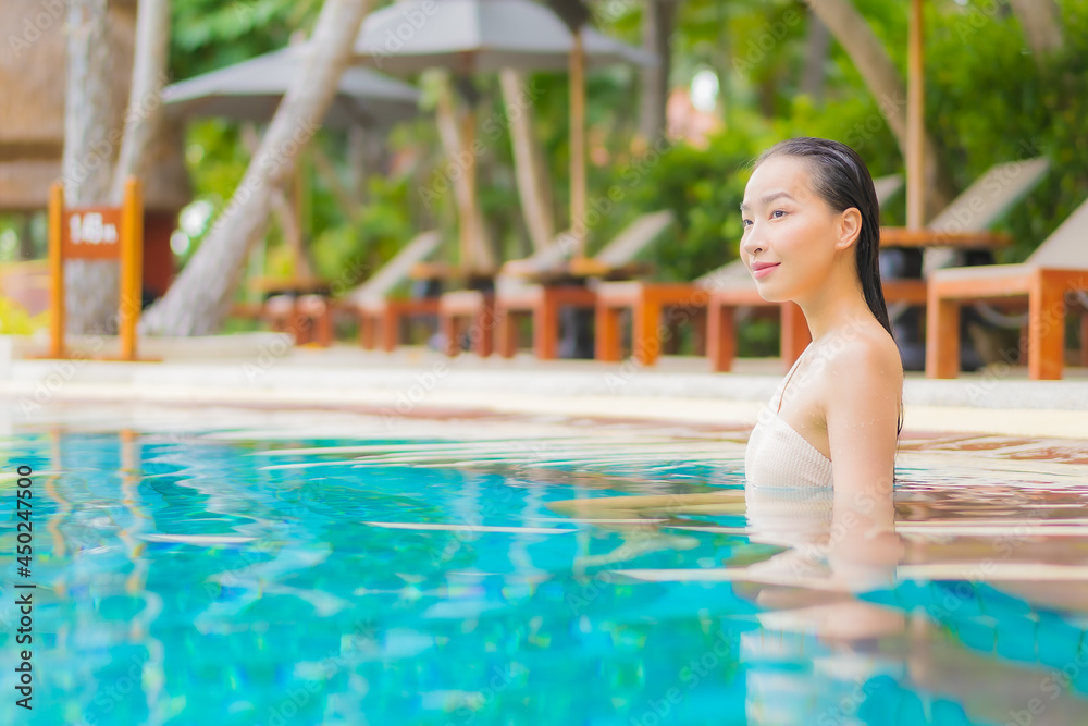 Portrait beautiful young asian woman relax around outdoor swimming pool