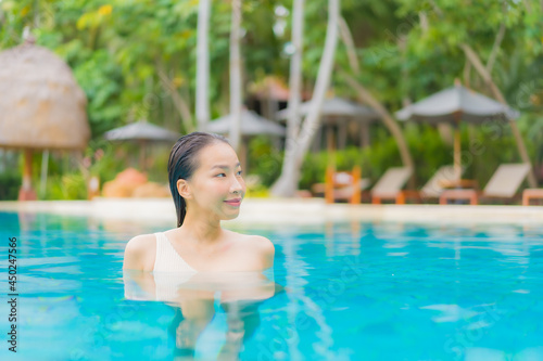 Portrait beautiful young asian woman relax around outdoor swimming pool © siraphol
