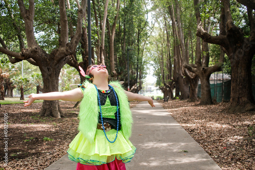 Young girl wearing crazy fluoro dress-up in woodland
