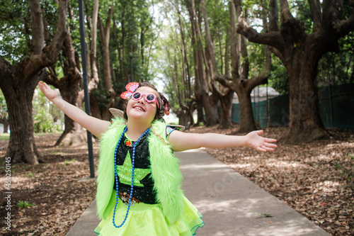 Young girl wearing crazy fluoro dress-up in woodland photo