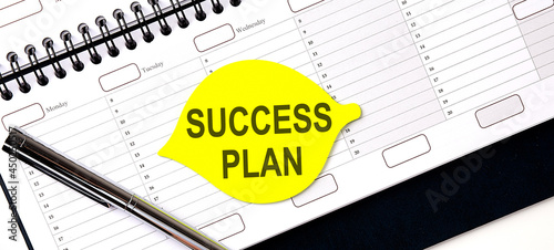 Text SUCCESS PLAN , on the yellow sticker on the planning