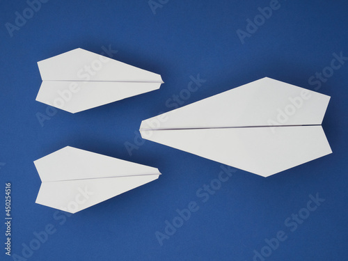 Flat masonry of white paper plane on a pastel blue background © Mikhail