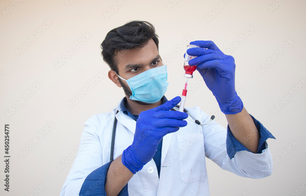 A doctor filling a syringe from the bottle for vaccination A doctor filling a syringe from the bottle for vaccination