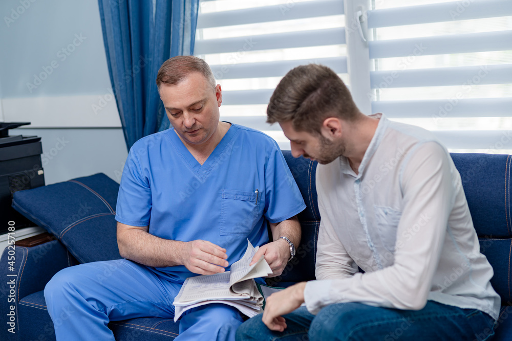 Doctor discussing with patient his test results. Medical worker explaining the results. Doctor discussing with patient his test results. Medical worker explaining the results.
