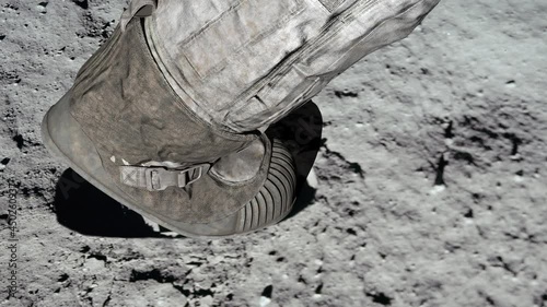 Lunar astronaut walking on the moon's surface and leaves a footprint in the lunar soil. 3d rendering.  photo