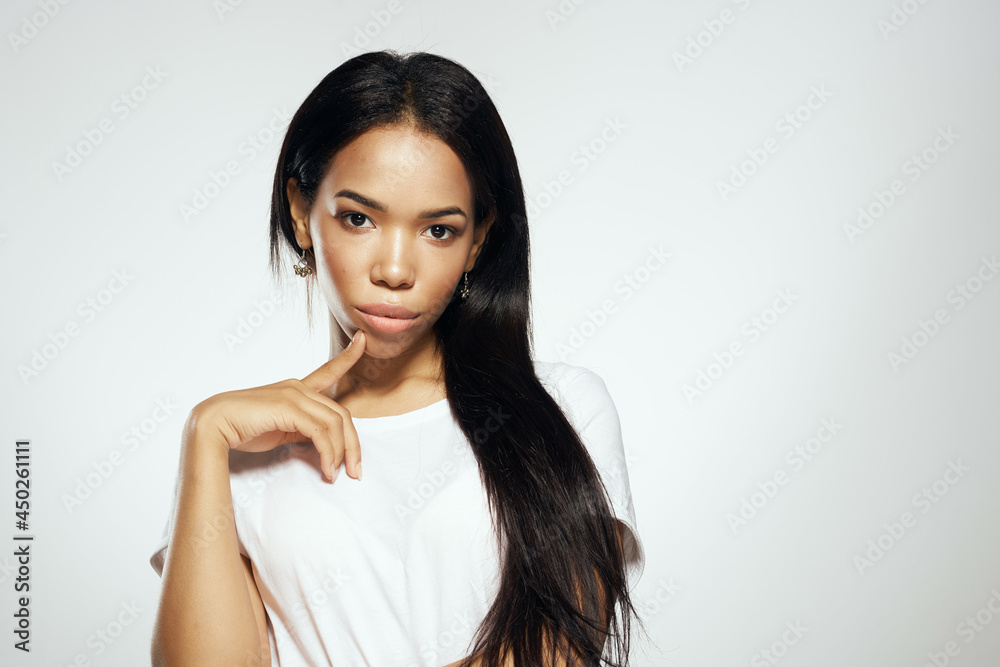 woman of african appearance with long hair in white t-shirt cosmetics