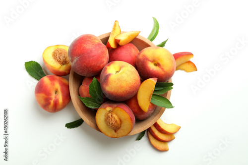 Fototapeta Naklejka Na Ścianę i Meble -  Wooden bowl with peach fruits on white background