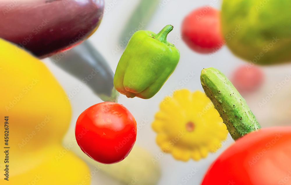 Vegetables levitating in the air pepper, cucumber, zucchini, eggplant and tomato on a white background Vegetables levitating in the air pepper, cucumber, zucchini, eggplant and tomato on a white background