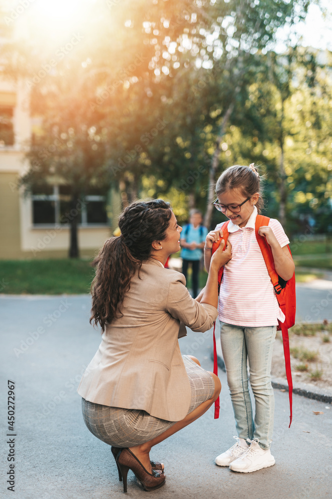 © hedgehog94 - First day at school. Mother leads a little child school girl in first grade. © hedgehog94 - First day at school. Mother leads a little child school girl in first grade.