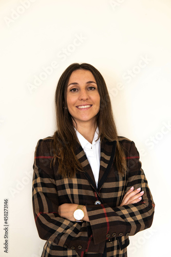 Obraz na płótnie Photo of a young and attractive woman looking corporative with a shirt smiling at the camera, looking professional and ready to do bussiness with a white background w salonie