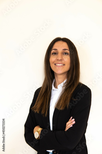 Obraz na płótnie Photo of a young and attractive woman looking corporative with a shirt smiling at the camera, looking professional and ready to do bussiness with a white background w salonie