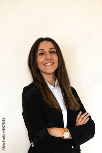 Photo of a young and attractive woman looking corporative with a shirt smiling at the camera, looking professional and ready to do bussiness with a white background	