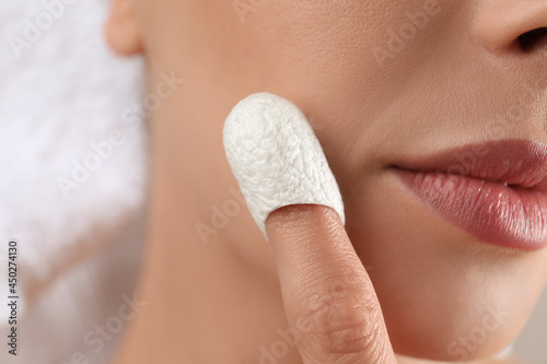 Woman using silkworm cocoon in skin care routine, closeup photo