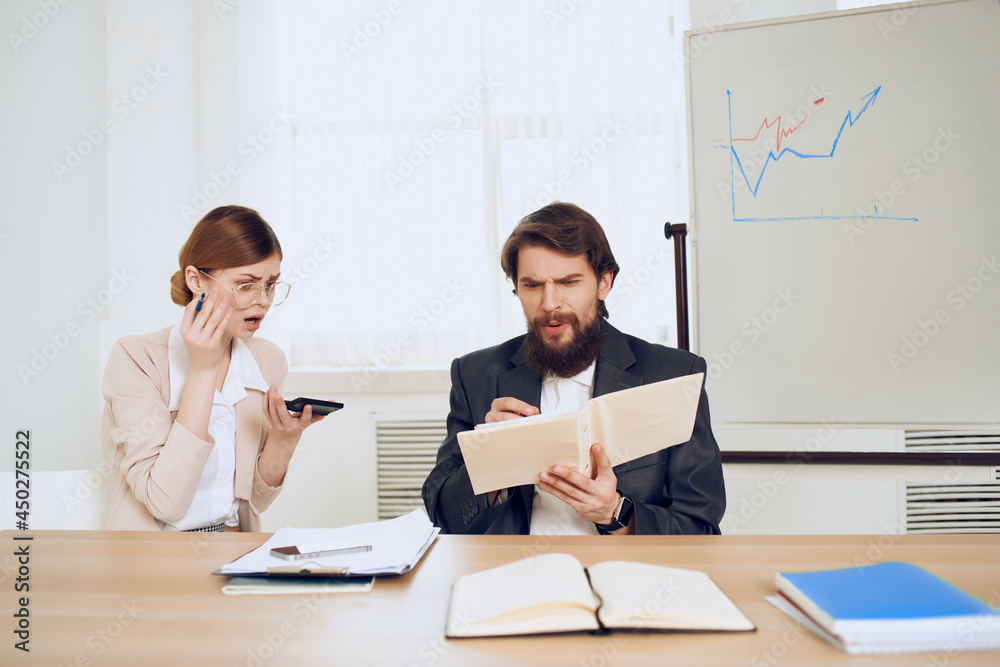 business man and woman sitting at work table screaming dissatisfaction communication emotions