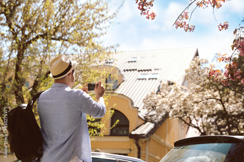 Tourist taking picture on beautiful city street