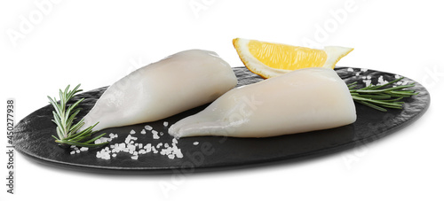 Fresh raw squid tubes with lemon, rosemary and salt on white background