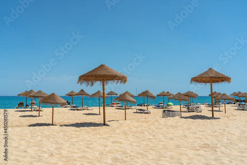 View of the luxury beach on the sea with sun loungers and umbrellas, in the tourist zone of the tropics.