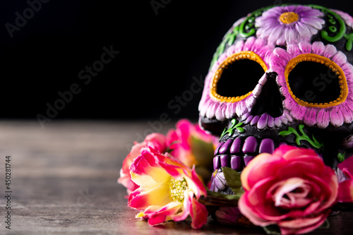 Fototapeta Naklejka Na Ścianę i Meble -   Typical Mexican skull and flowers diadem on wooden table. Copy space