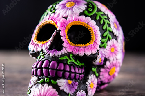 Fototapeta Naklejka Na Ścianę i Meble -   Typical Mexican skull and flowers diadem on wooden table