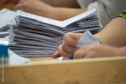Vászonkép person counting ballot papers at an election