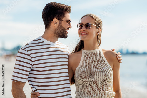 summer holidays and people concept - happy couple on beach