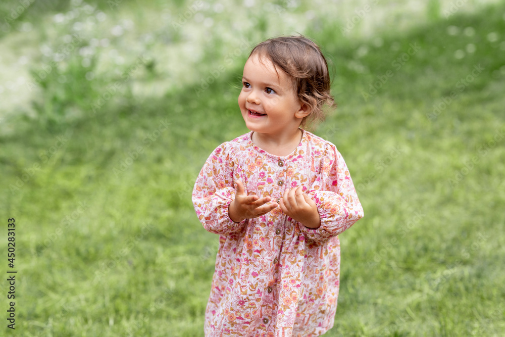 childhood, leisure and people concept - happy little baby girl in pink dress outdoors in summer childhood, leisure and people concept - happy little baby girl in pink dress outdoors in summer