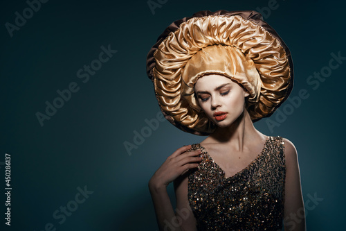 pretty woman in big golden hat vintage lifestyle glamor