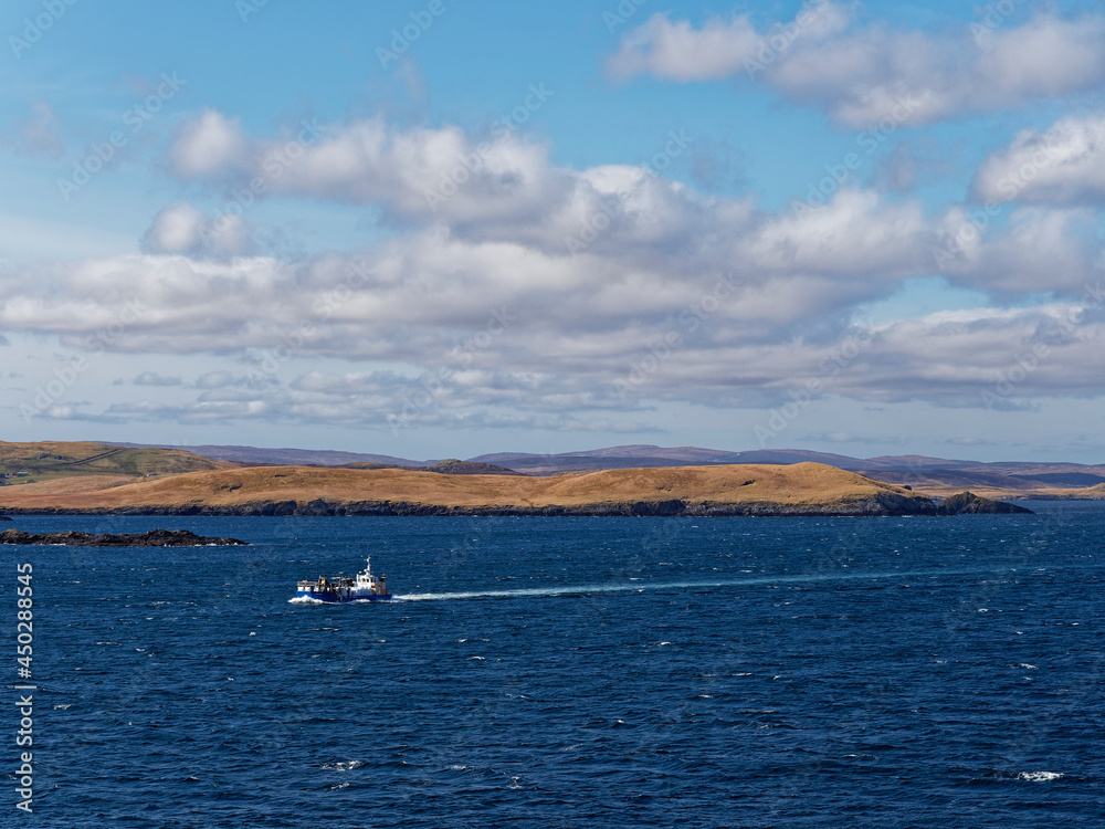 A General Cargo Vessel entering the Northern Approaches into Lerwick Port, passing the South Bight of Rovahead sea Cliffs.