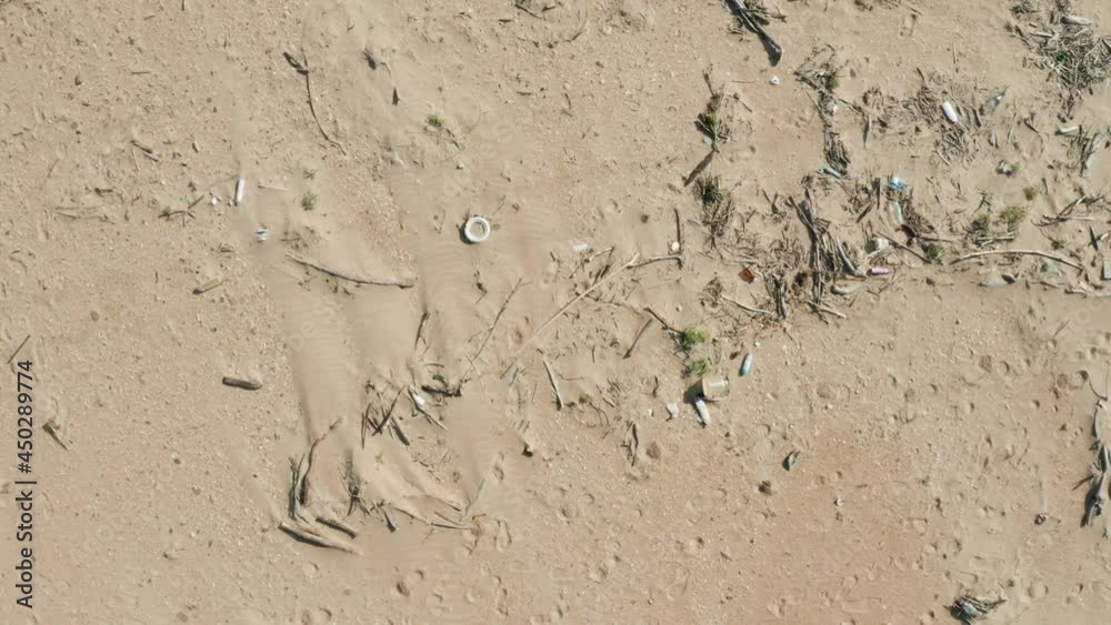 A beach polluted by people, aerial view from a drone. A sad view of a coastline filled with debris. A beach polluted by people, aerial view from a drone. A sad view of a coastline filled with debris.