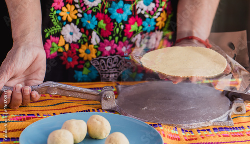 фотографія Tortilla press, testales (maize dough) and resulting mexican tortillas